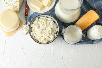 Flat lay. Different dairy products on white background, copy space