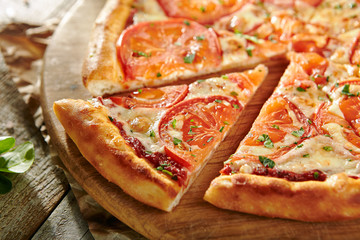 Pizza Restaurant Menu - Delicious Fresh Margarita Pizza with. Pizza on Rustic Wooden Table with...