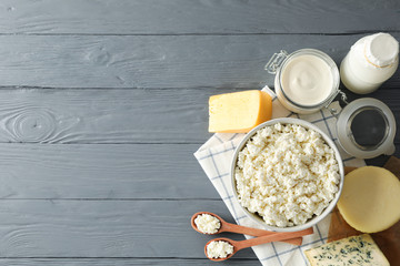 Flat lay. Different dairy products on grey wooden background, copy space