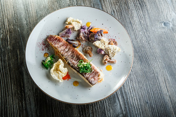 trendy decorated delicious roasted fish fillet and vegetables