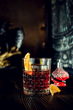 sazerac cocktail on dark wooden background with copy space
