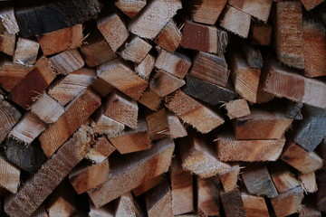 Firewood dry firewood in a pile for furnace kindling. Rustic background of logs
