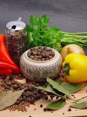 Still life food with dishes wooden table. There are onion, pepper, chili pepper, parsley, dried laurel leaves and peppercorns on the table.