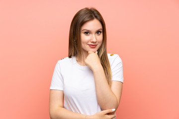 Teenager girl over isolated pink wall laughing