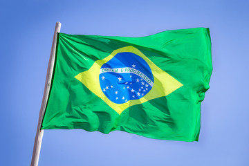Brazil national flag textile cloth waving on top, blue sky brazil, patriotism concept.