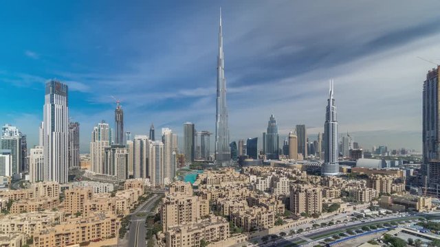 Dubai Downtown skyline all day timelapse with Burj Khalifa and other towers paniramic view from the top in Dubai, United Arab Emirates. Shadows moves very fast. Traffic on circle road