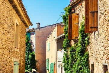 Old architecture in Valensole, Provence, France. Stone houses and windows with wooden shutters