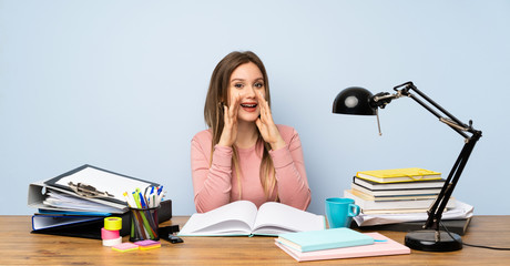 Teenager student girl in her room shouting with mouth wide open