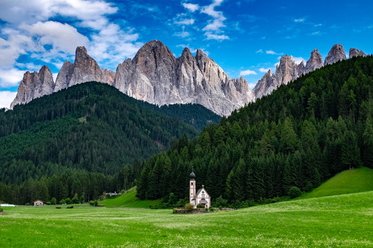St Giovanni in Ranui church with Odle mountains above , Funes, Val di Funes, Italy.