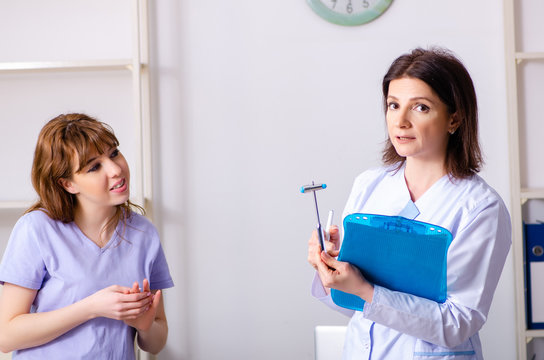 Young woman visiting female doctor physiotherapist
