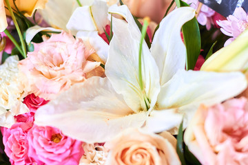 Bouquet of flowers consists of lilies, roses, astras. close up cropped photo. summer mood, wonderful smell, magic composition