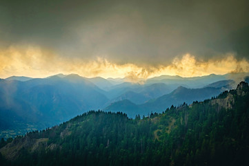 Mountain landscape. Sunset in the misty clouds