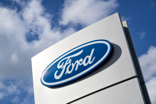 LEIDERDORP, THE NETHERLANDS - June 19, 2018: Ford dealership sign against blue sky. Ford is the second-largest U.S.-based automaker.