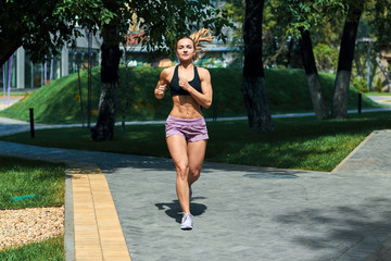 beautiful cheerful girl jogging in the morning, full length side view photo. health and body care, wellness, wellbeing, hobby, interest