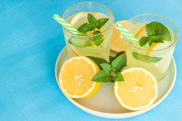 Lemonade or mojito cocktail with lemon and mint