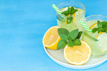 Lemonade or mojito cocktail with lemon and mint