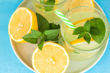 Lemonade or mojito cocktail with lemon and mint