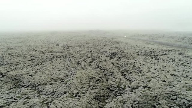 A road passes on a lava field in Iceland.