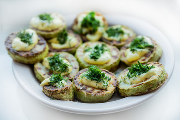 homemade zucchini fried with mayonnaise. On a white background