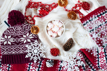 cup with marshmallows and Christmas or winter decor on  white background
