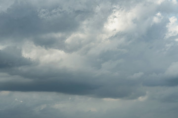Dark stormy sky with sunlight shining through.