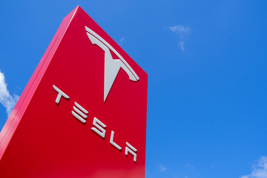 ROTTERDAM, THE NETHERLANDS - June 21, 2018: Tesla dealership sign against blue sky