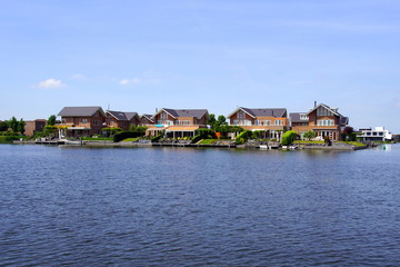 Fototapeta na wymiar Dutch houses on the waterside in the city of Almere. 
