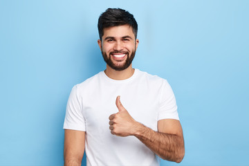 cheerful positive guy with beard rejoicing at his friend's success, close up portrait, body...