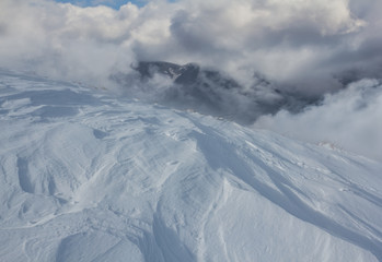 winter mountain scene, mount in a snow and dense clouds