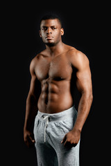 strong male boxer with serious expression having a rest after training, workout. wellbeing, hobby, interest. close up portrait. isolated black background.