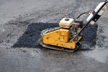 Asphalt vibratory plate compactor. Pothole repair process. Asphalt tamping machine. Pothole...