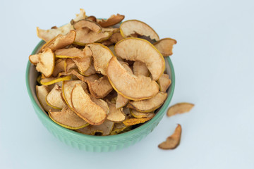 Apple quince chips in a green bowl isolated healthy food