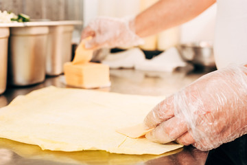 cropped view of cook in gloves preparing doner kebab