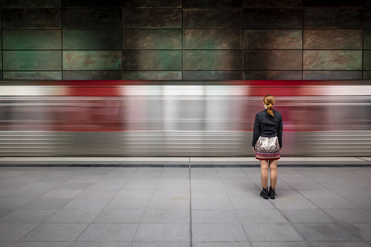 Girl in front of passing underground train
