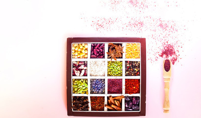 The concept of cereals organic products and spices on pink background