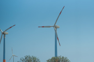 Eco power. Wind turbines generating electricity against clear sky.