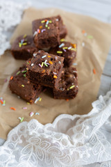 Banana brownies with multi colored sprinkles, crinkled parchment paper, lace fabric