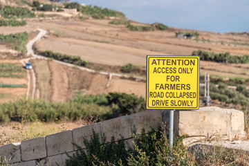 Sign advising motorists that a road has collapsed, and access is for farmers only, Xaghra, Gozo, Mallta