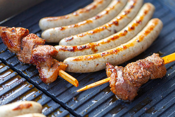 A lot of sausages lies on a grill