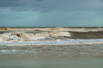 Tidal waves at beach near the Hague, the Netherlands, in windy day. North sea abstract natural background in June.