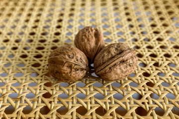  Three walnuts on a wicker stool 