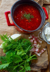 photo for menu, Russian borscht in red pot with sour cream garlic, bread, parsley, dill, lard, Ukrainian borscht with sour cream, food background, Food and health
