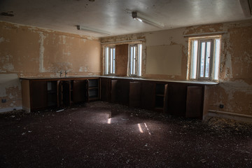Stripped-out kitchen in an abandoned prison.