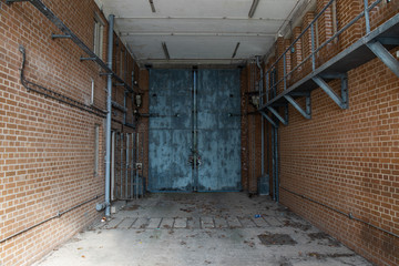 Hydraulically operated steel gates inside the vehicle bay of a prison.