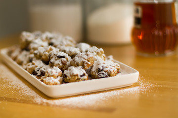 plate of christmas cookies with sugar and flour in the background