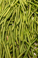 A full frame photograph of green beans for sale on a market stall