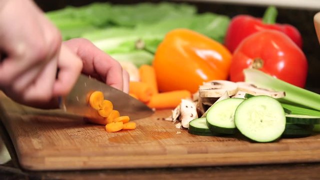Man cutting carrots close up