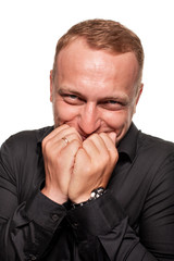 Naklejka premium Handsome young blond man in a black shirt, isolated on a white background