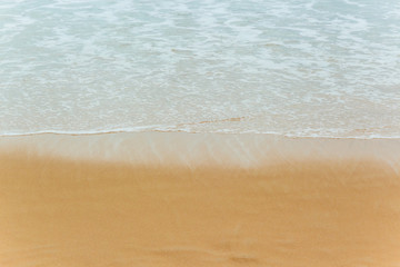 Soft Blue ocean wave on sandy beach. tropical white sand With the sea at the corner.