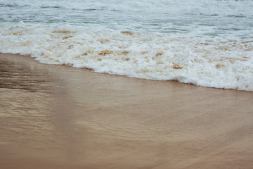 Soft Blue ocean wave on sandy beach. tropical white sand With the sea at the corner.